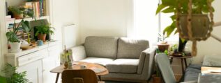 gray fabric loveseat near brown wooden table